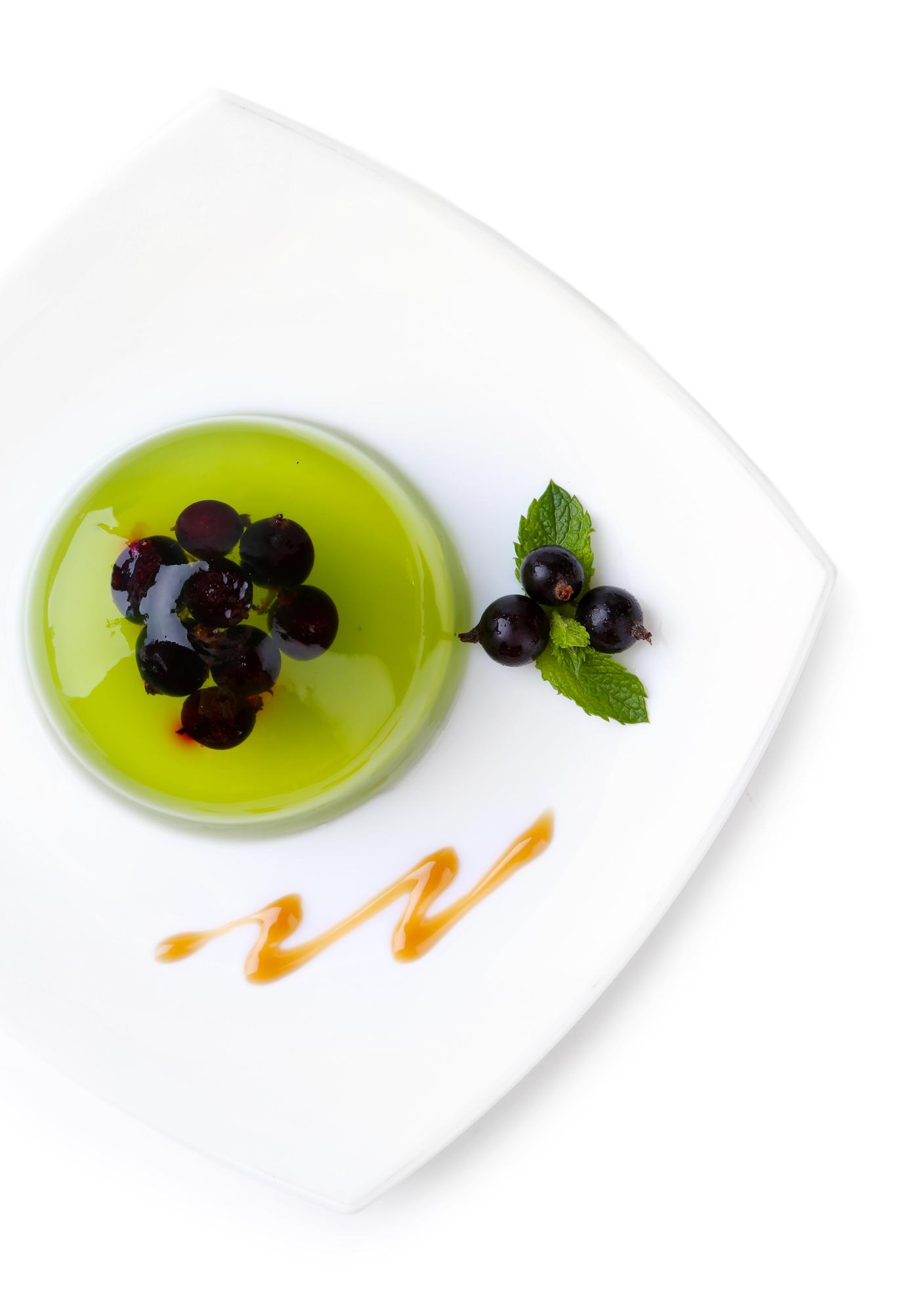 Minimalist plated dessert with glossy glaze and micro herbs